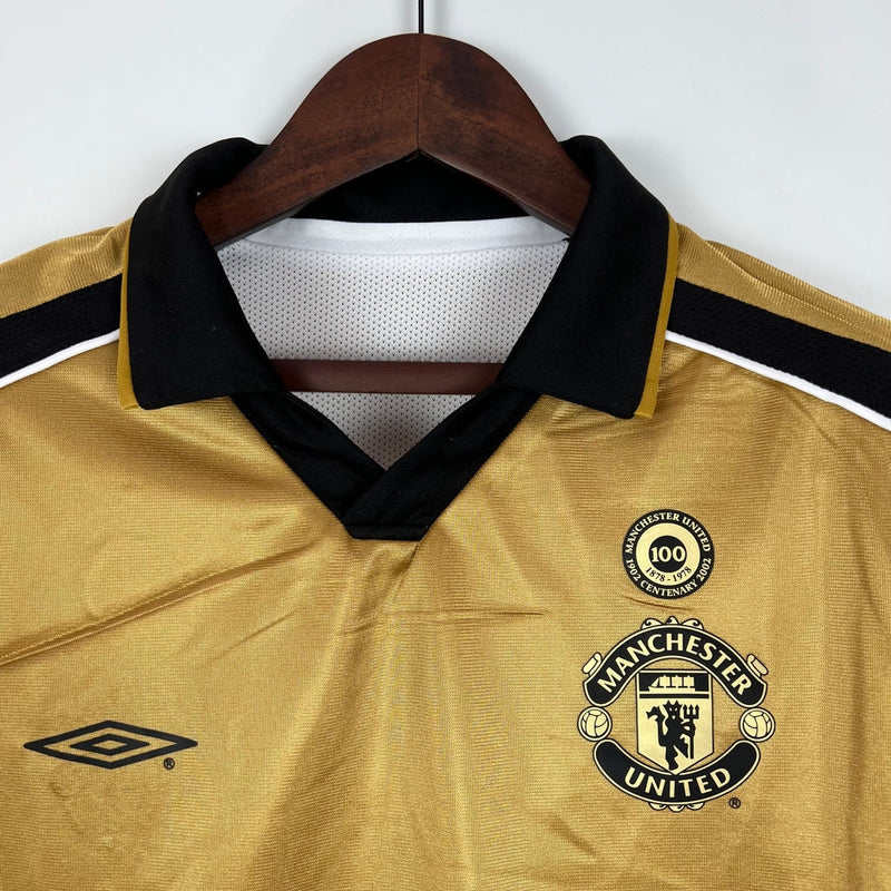 Camisa Dupla Face Retrô Manchester United Umbro 2001/02 100 Anos Masculina Branca e Preta ou Dourada